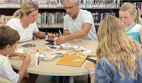 Image of LOCA at the Library crafting at table